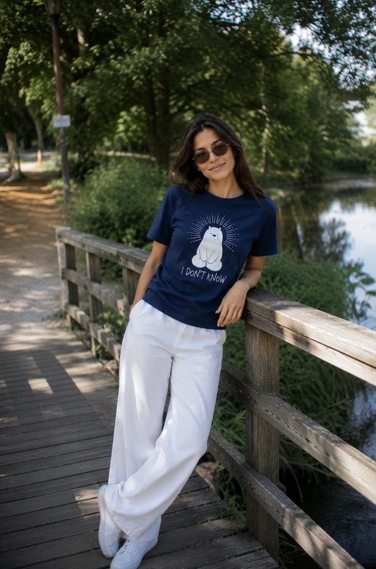 Woman wearing the navy I don't know statement t-shirt on a lakeside boardwalk